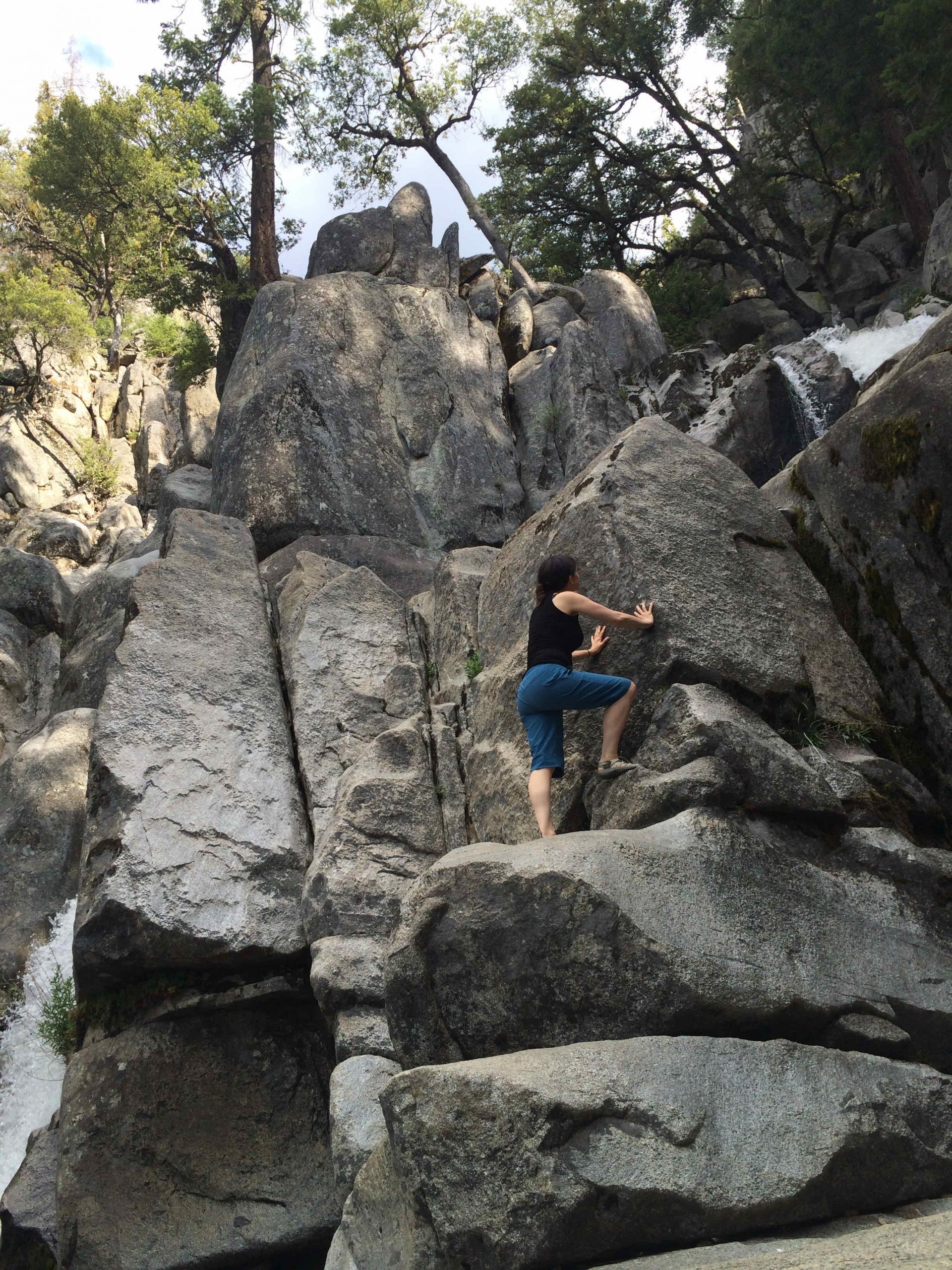 Person climbing large rocks outdoors